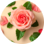 Mint leaves swirl around a damascena rose.